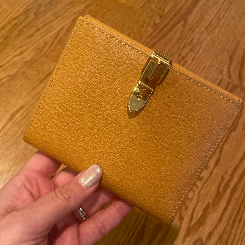 Gucci compact wallet with goldtone hardware. Buckle closure needs fixing.